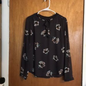 Brown floral blouse.